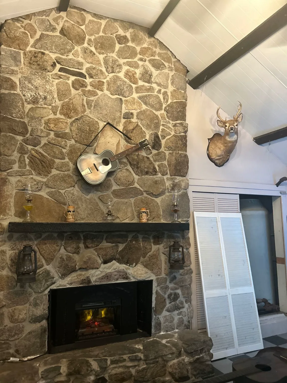 The stone fireplace inside The Wooden Tavern
